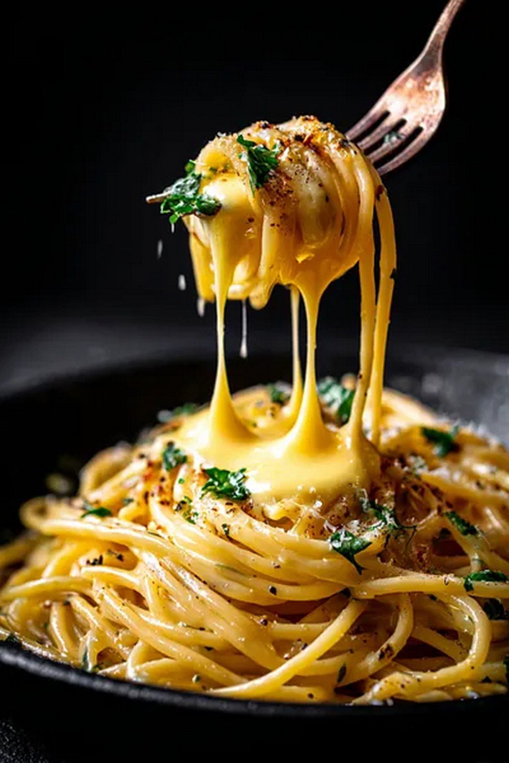 fork lifting spaghetti with creamy carbonara sauce
