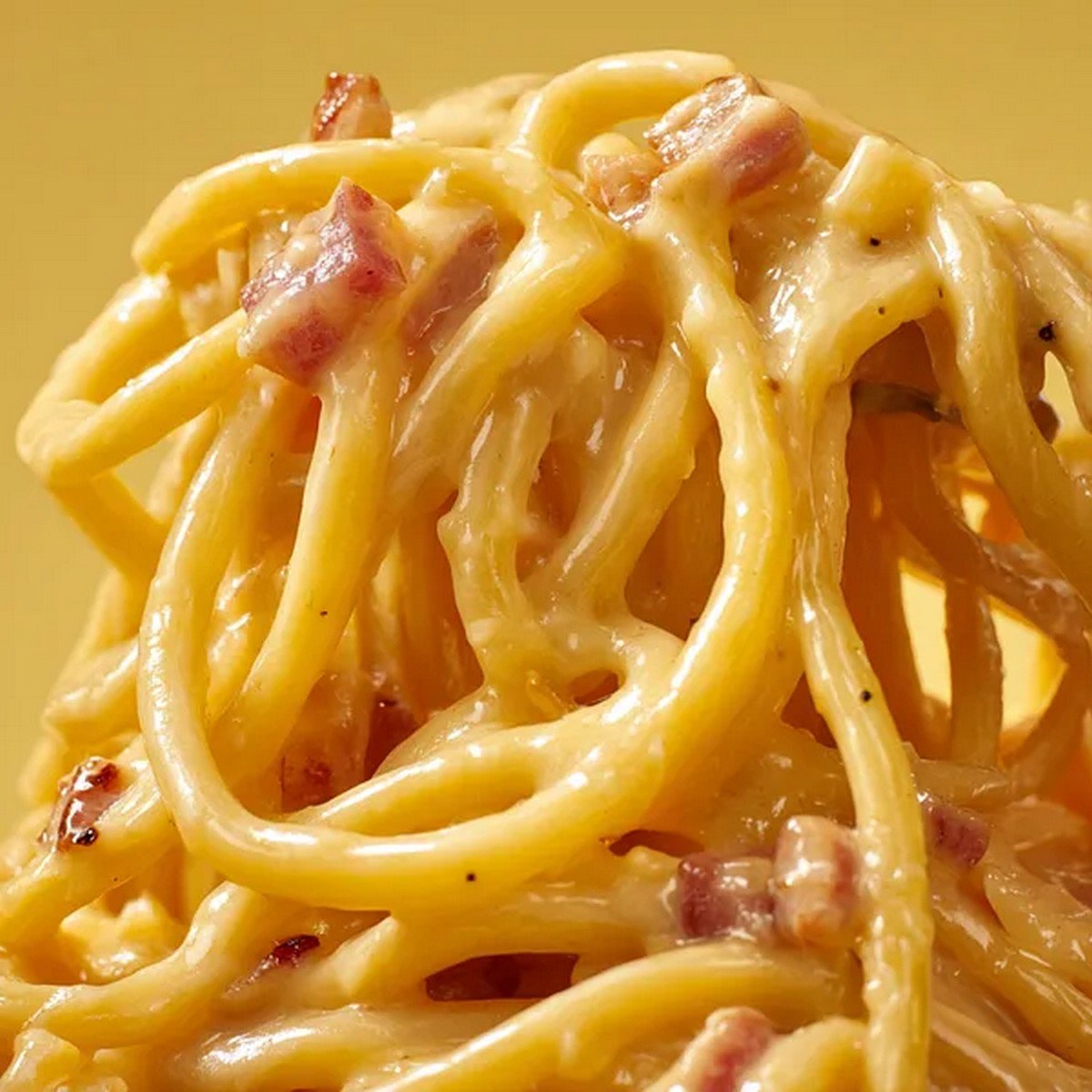 creamy carbonara sauce texture with egg and cheese coating pasta
