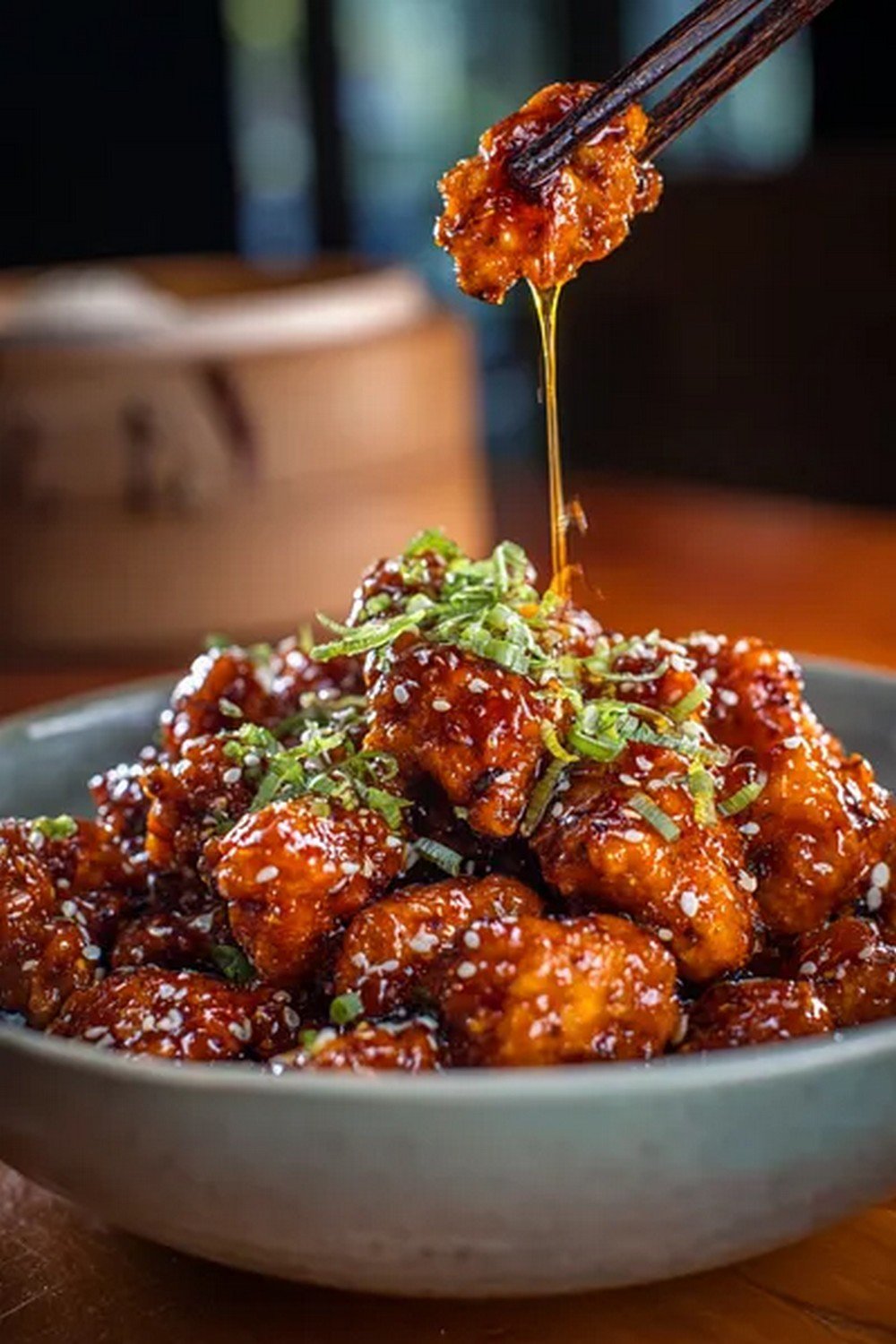 Action dip shot of Panda Express Orange Chicken
