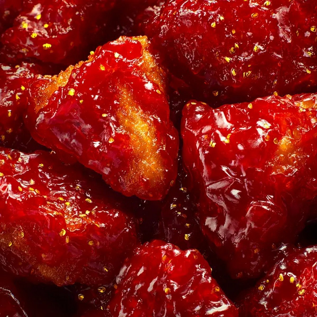 sweet and sour chicken sauce close up coating crispy chicken

