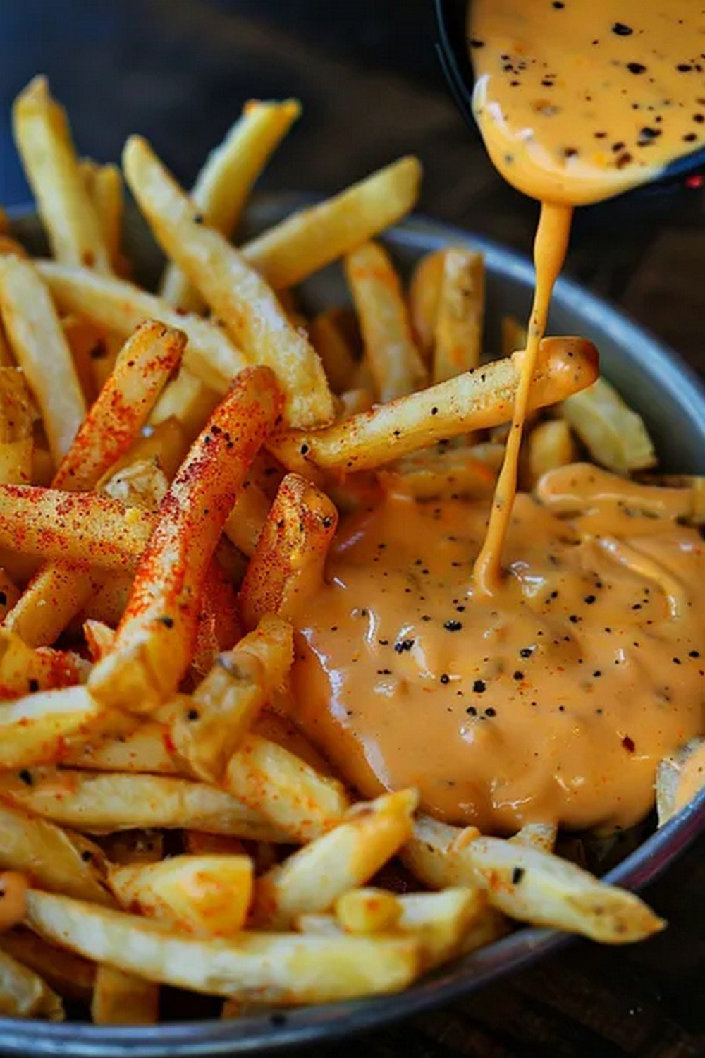 fries dipped into creamy pepper sauce with coating
